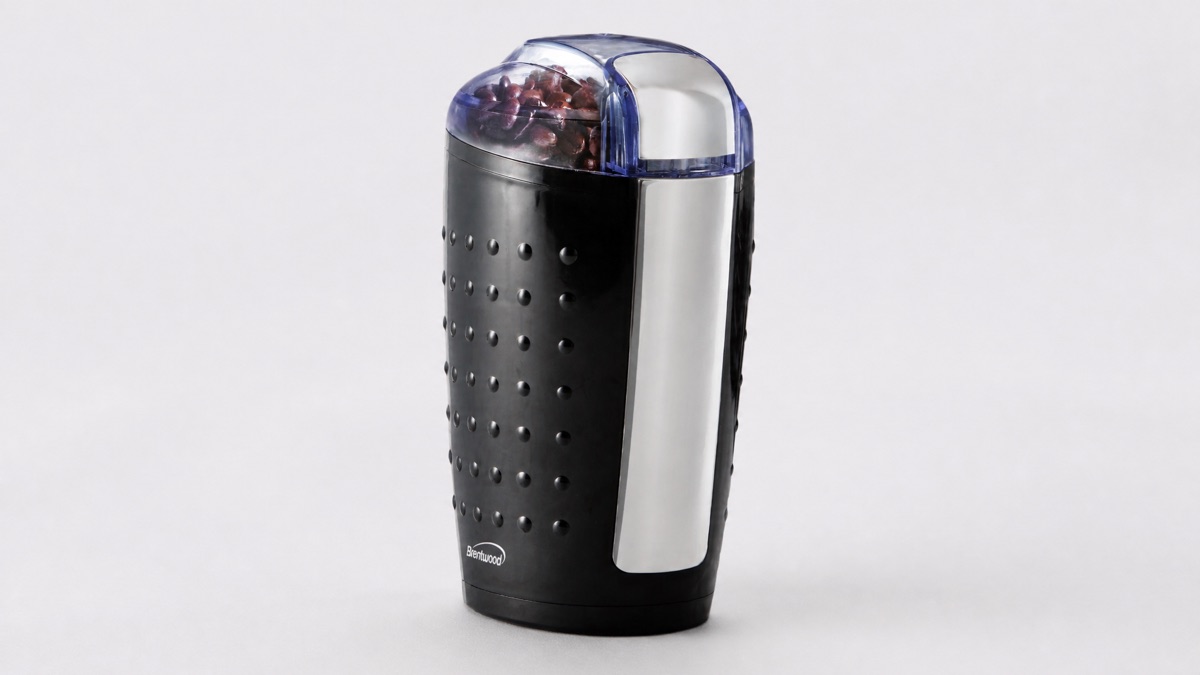 Black Brentwood CG-158 electric blade coffee grinder with coffee beans under a clear lid