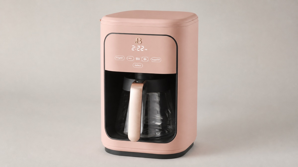 Beautiful 14-cup programmable coffee maker in rose with a glass carafe on a plain background