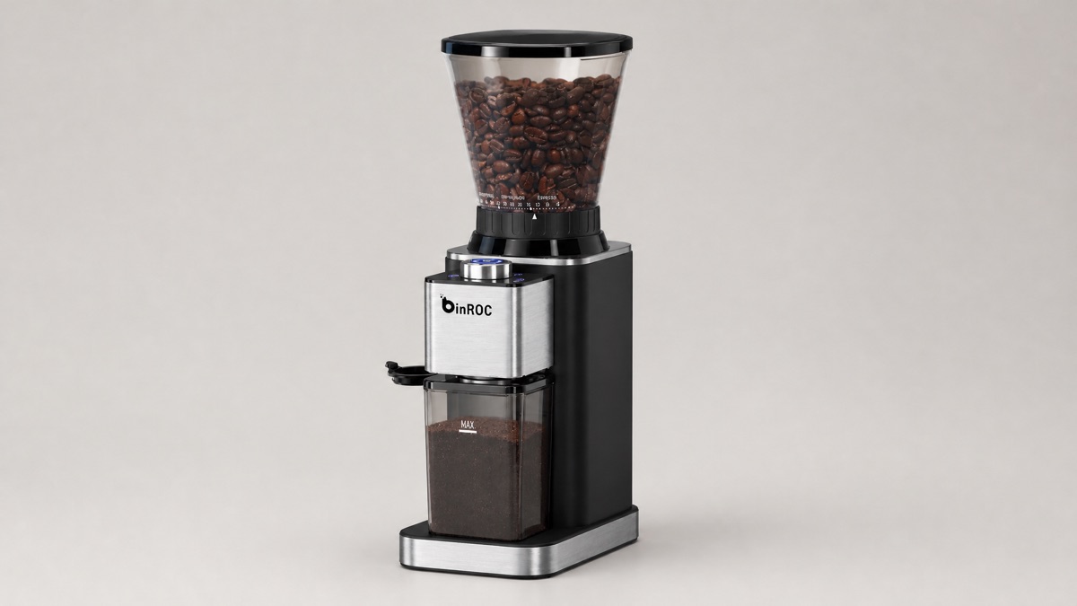 Black and stainless steel binROC conical burr coffee grinder filled with roasted beans