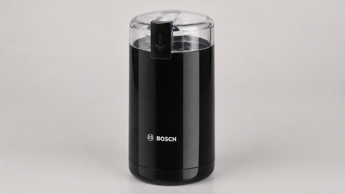 Black Bosch TSM6A013B electric blade coffee grinder with a clear lid and push switch