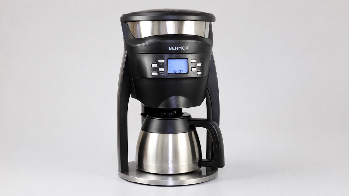 Behmor Brazen Plus drip coffee maker with a stainless steel thermal carafe on a plain background