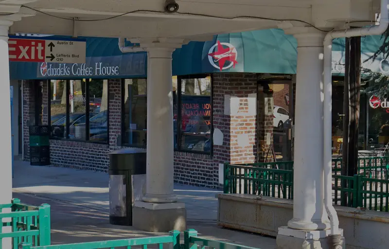 The Odradeks Coffee House storefront under the station canopy on Austin Street